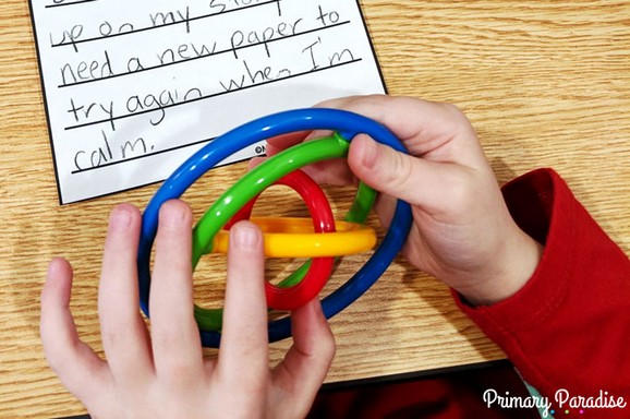 Image of student holding a colorful girobi fidget tool