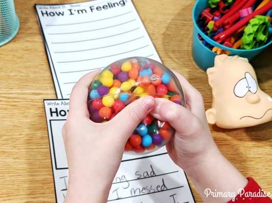 Image of Student squeezing a colorful sensory bead ball