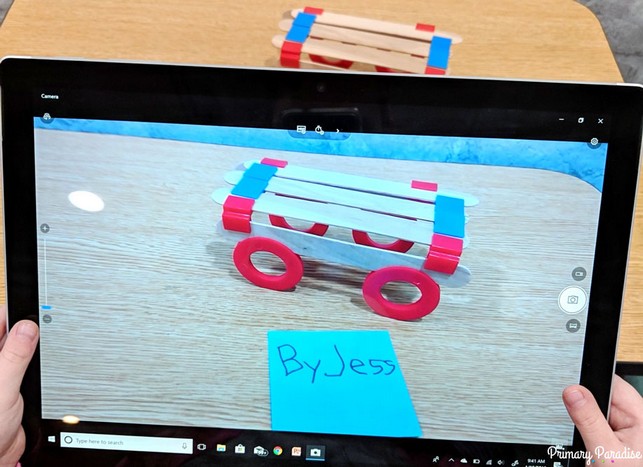 Image of student taking a picture of their STEM creation, a car, for accountablilty