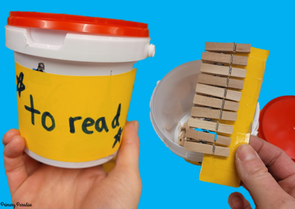 On the left, a hand holding a plastic container with "to read" written on it, on the right, a hand holding a strip of yellow cardboard with clothespins on it.