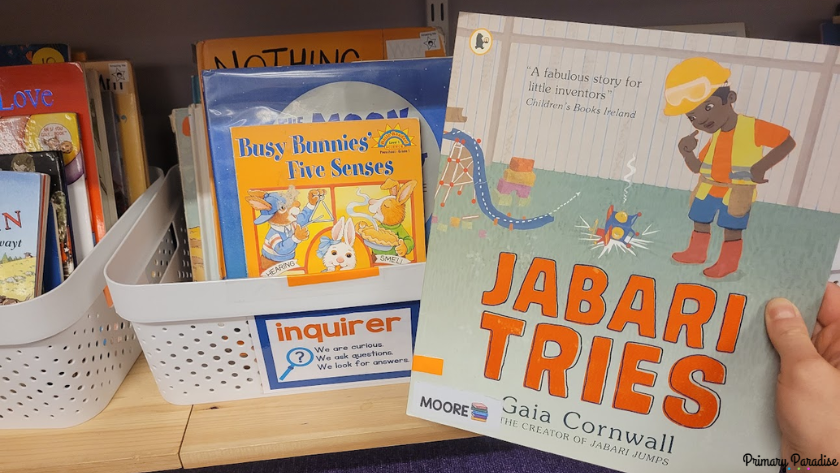 A picture of a book basket that says "inquirer" and has orange tape with a copy of Jabari tries with matching orange tape on the spine.