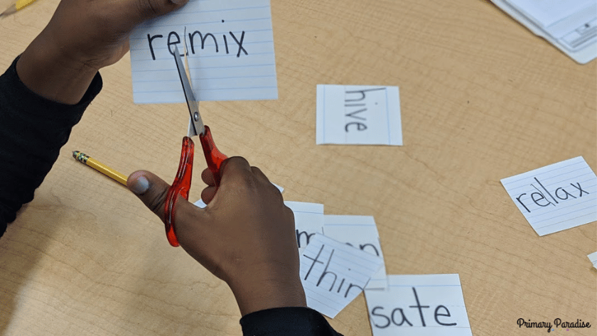 An image of hands cutting the word "remix" into two syllables